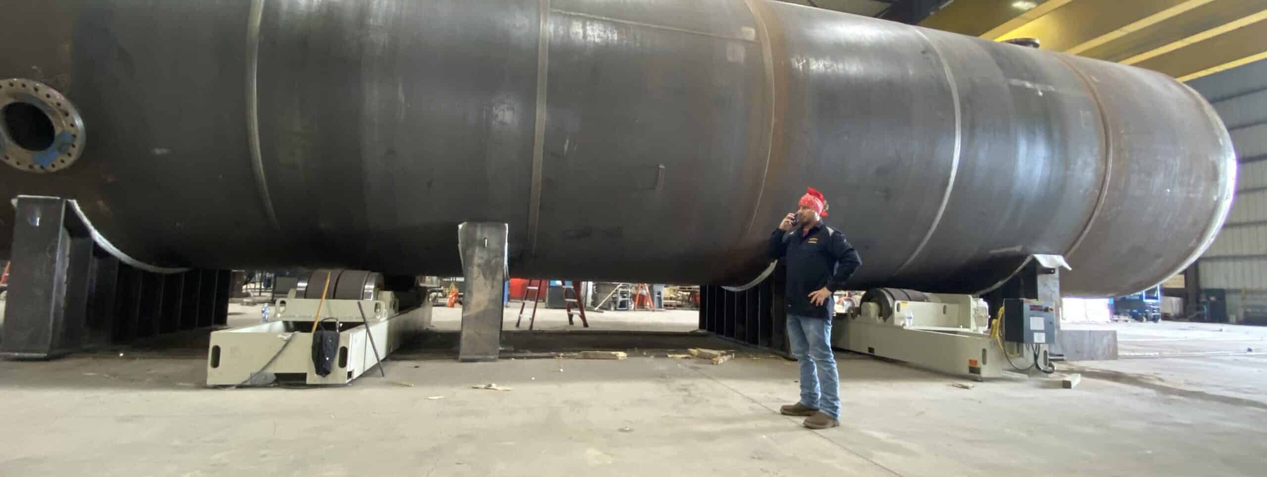 James Benefield on-site next to a large pressure vessel prior to PWHT — Gulf Coast Combustion